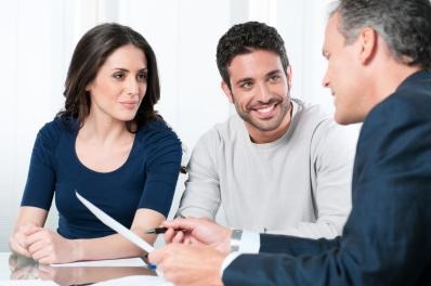 Financial consultant reviews investments with a couple