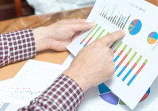 Hand pointing at graph.