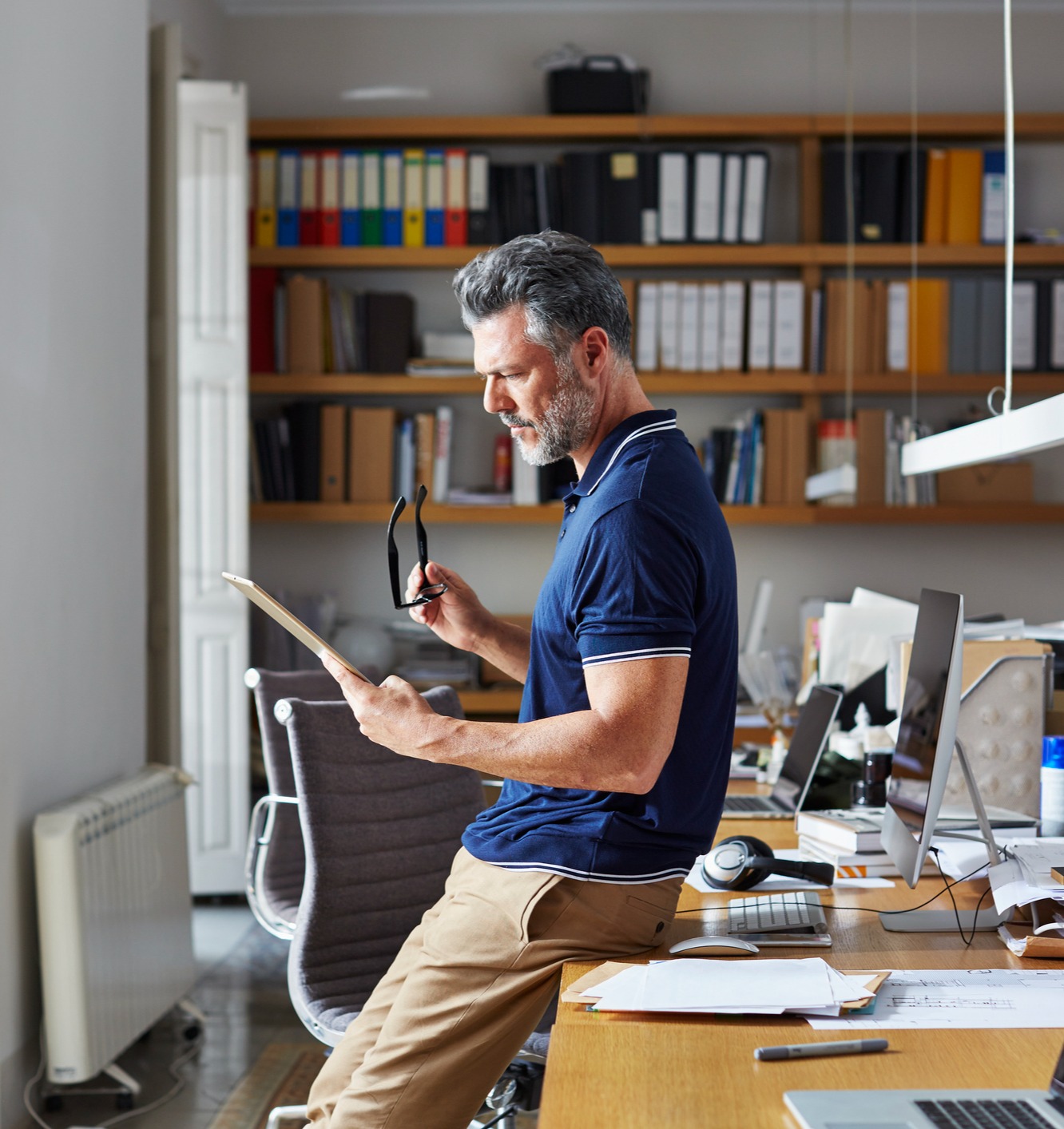 A mature man reviewing a document in his office