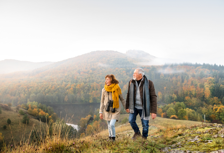 Photo of Couple Holding Hands in a Valley
