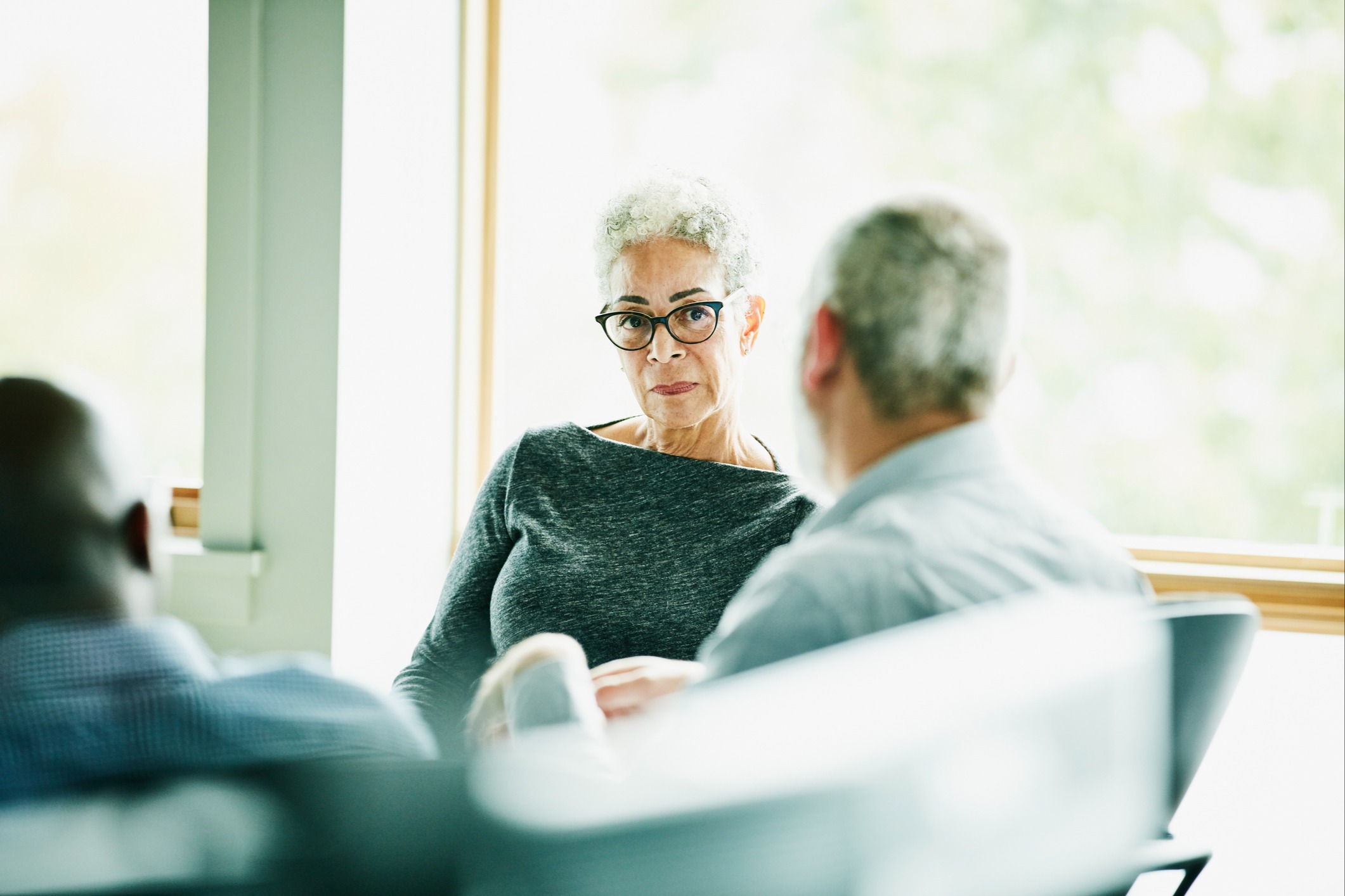 Woman and man sitting at desk having a meeting