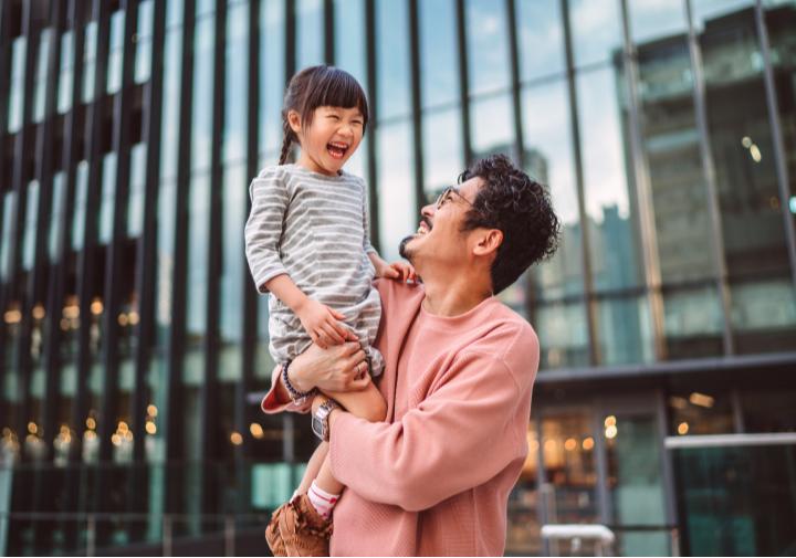 Father holding his child up to his shoulder.