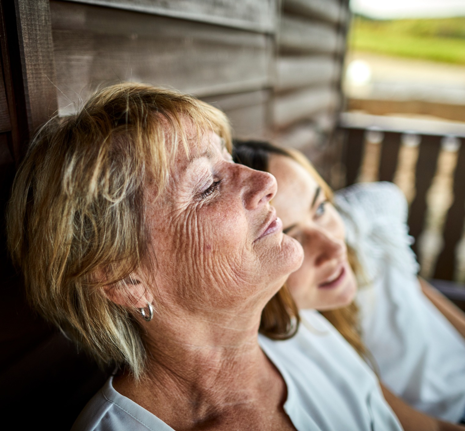 Mother and daughter sitting on porch