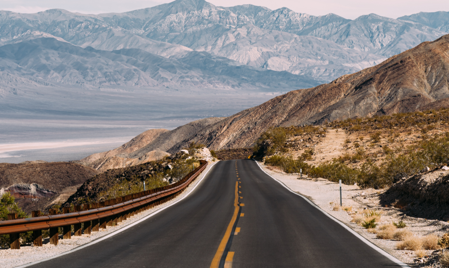 Paved road heading into the mountains.