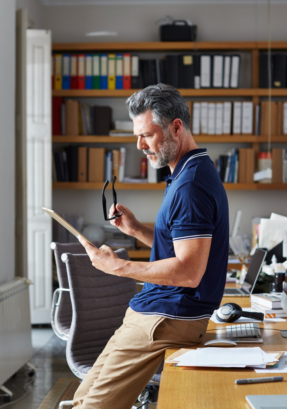 Man Looking at Notes in Office