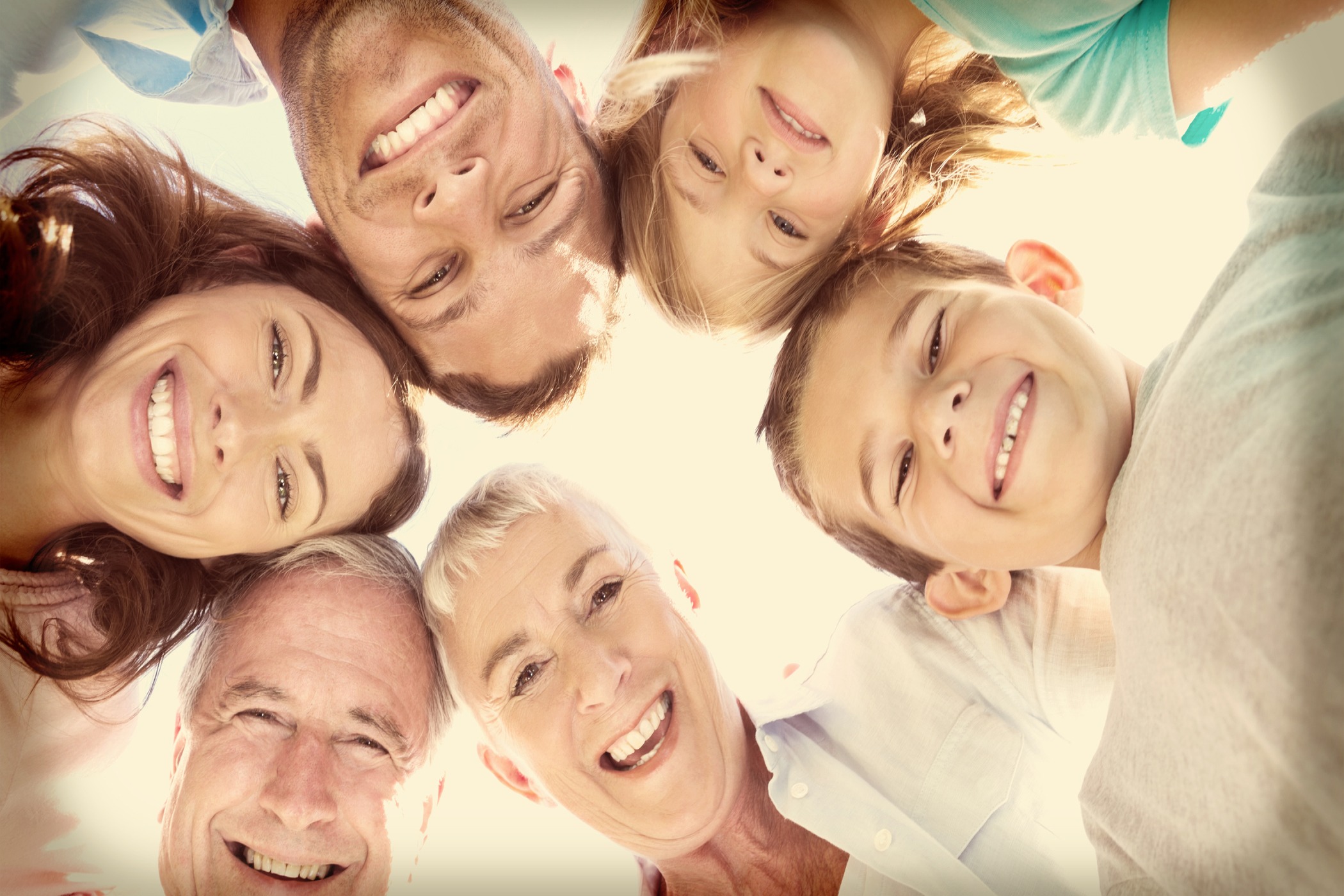 Multigenerational family smiling down at the camera