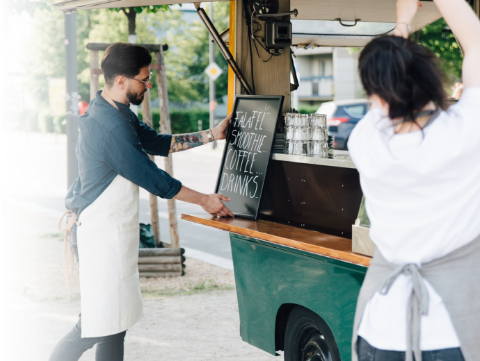 food truck workers putting signs out