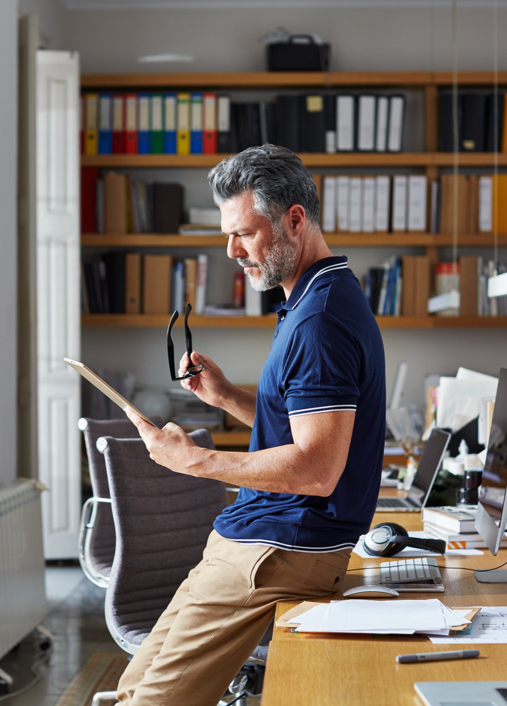 Mature man reviewing documents in his office