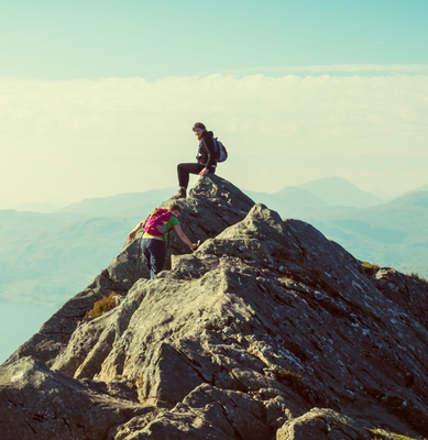 Mountain-Climbers-Sitting-On-Mountain-Peak