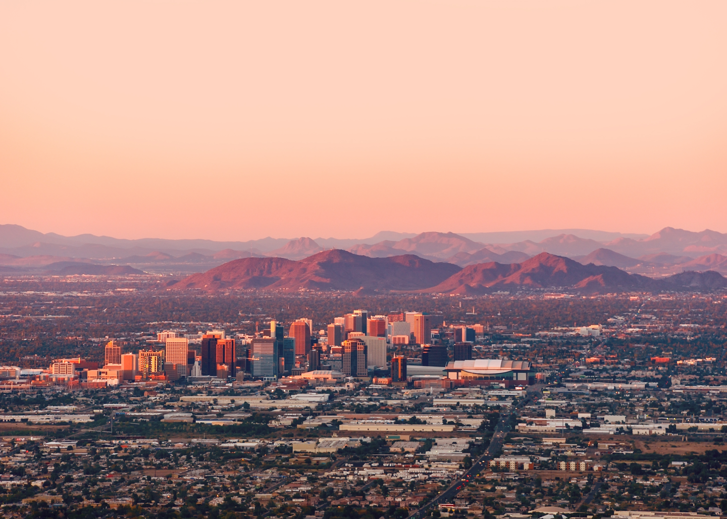 overview of city during sunset with mountains in background