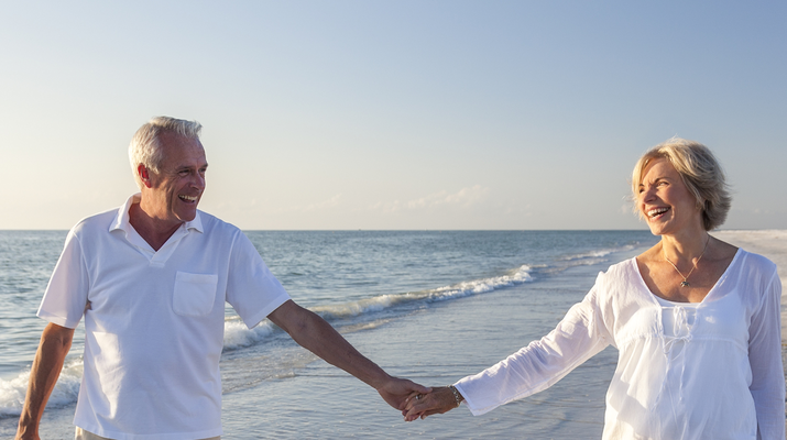 couple holding hands on beach