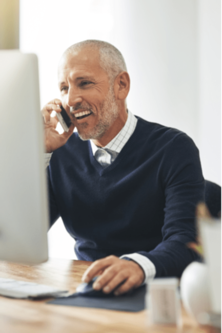 Man smiling while talking on the phone