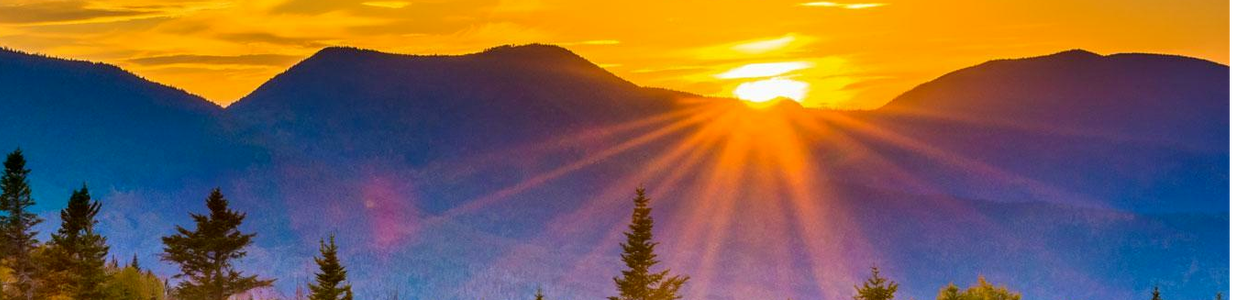 Sun setting behind a mountain