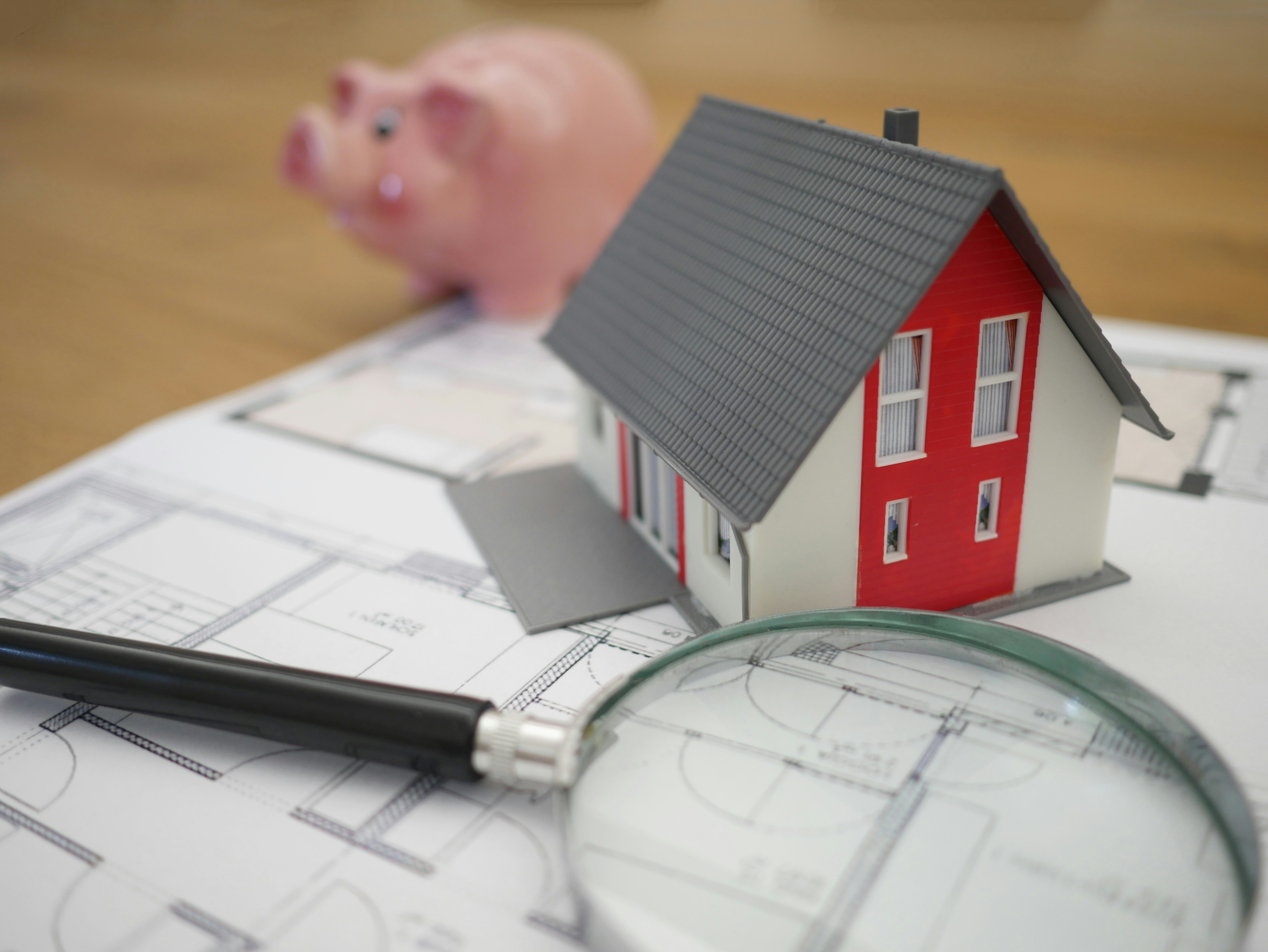 House, Blueprints, Magnified Glass, and Piggy Bank