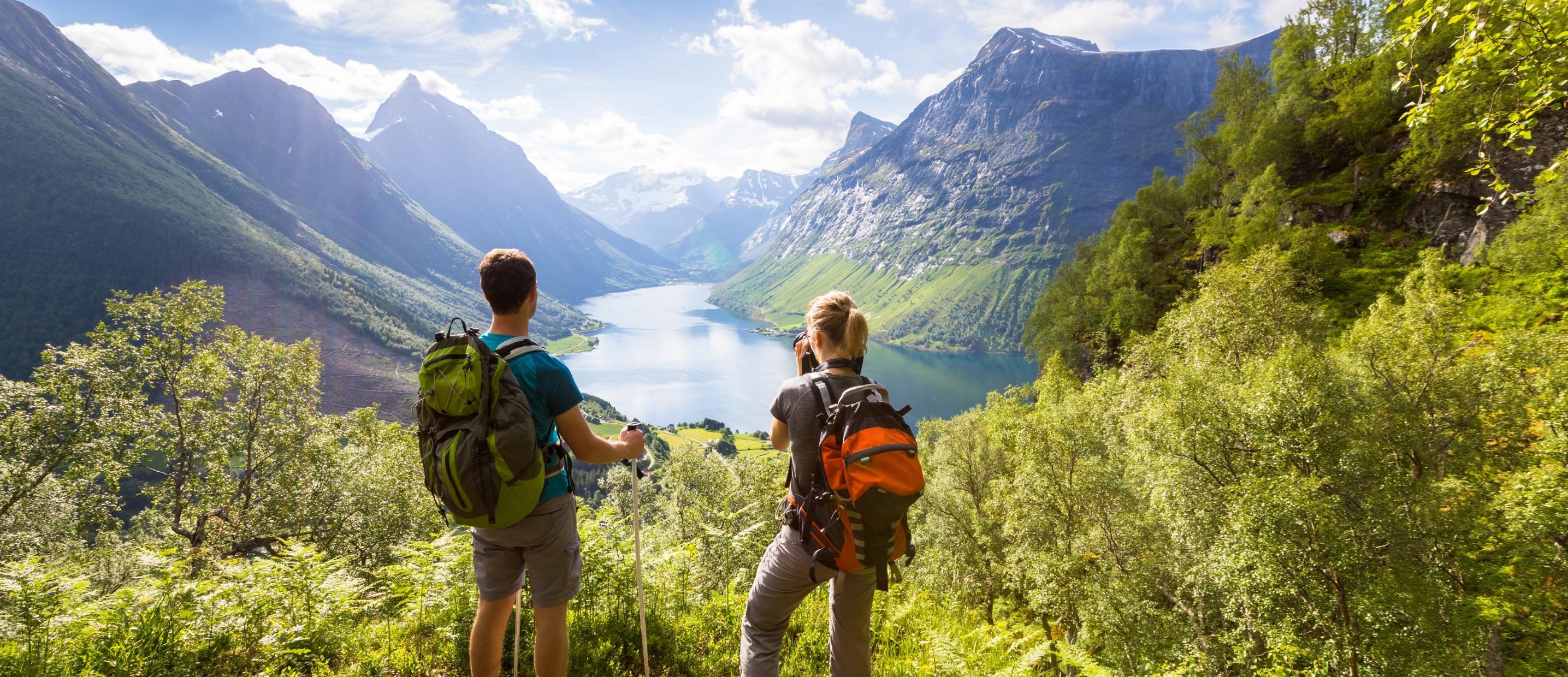 Photo of two people enjoying a beautiful valley view