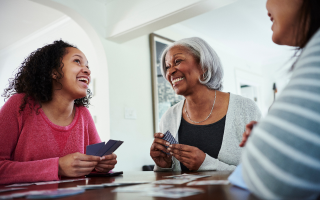 Girl laughing with grandparents at a counter