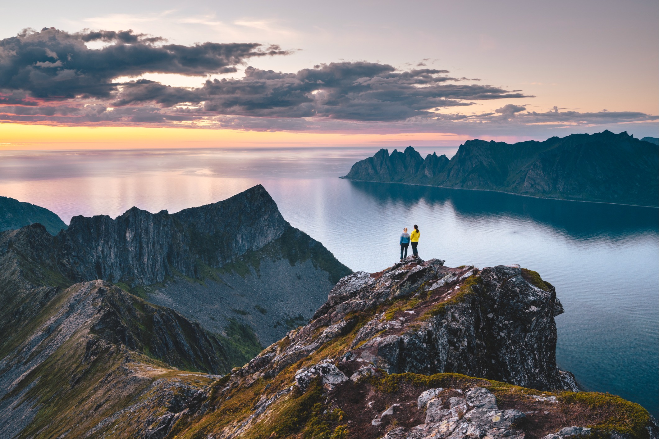 Couple looking over the mountains at sunset
