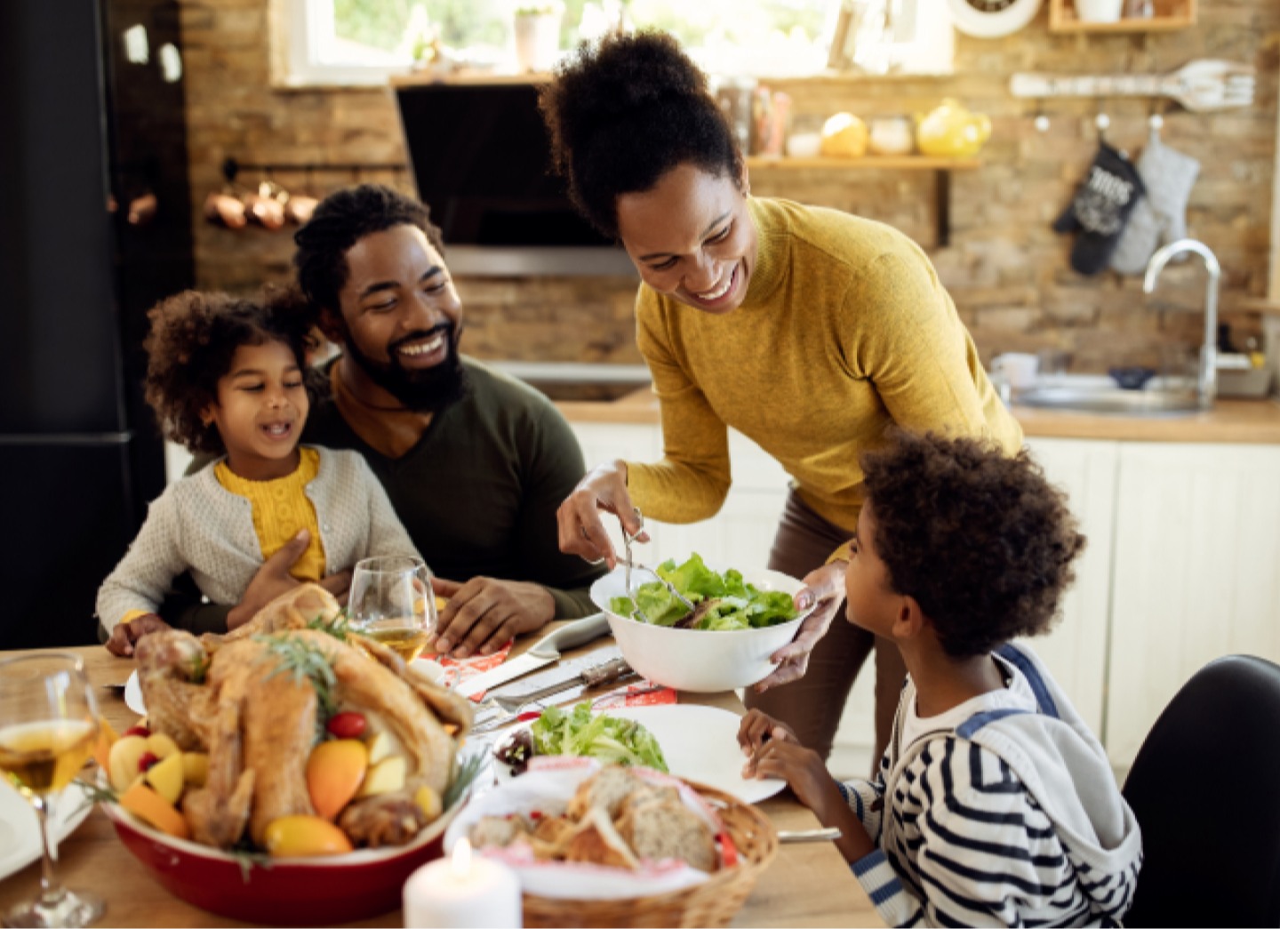 Mother serving kids at dinner table