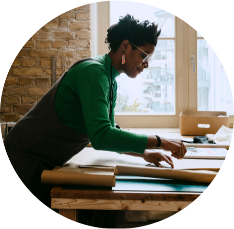 Woman working on a large piece of paper
