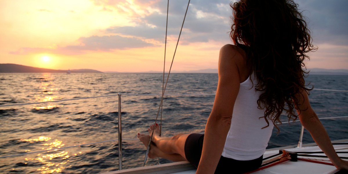 woman-on-boat-looking-at-water