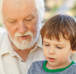 Grandfather reading with grandson