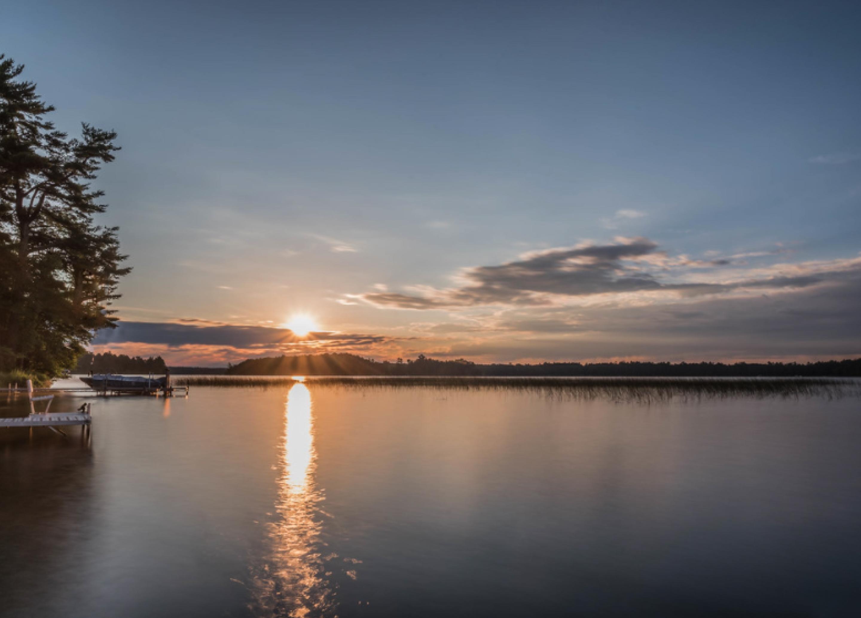 Photo of a sunrise above a body of water