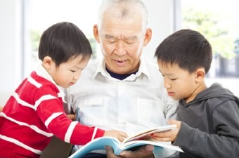 Old man reading to grandkids