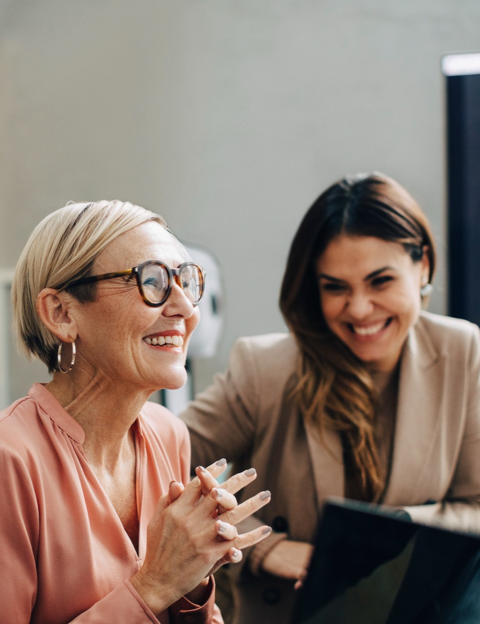 Two women smiling and laughing