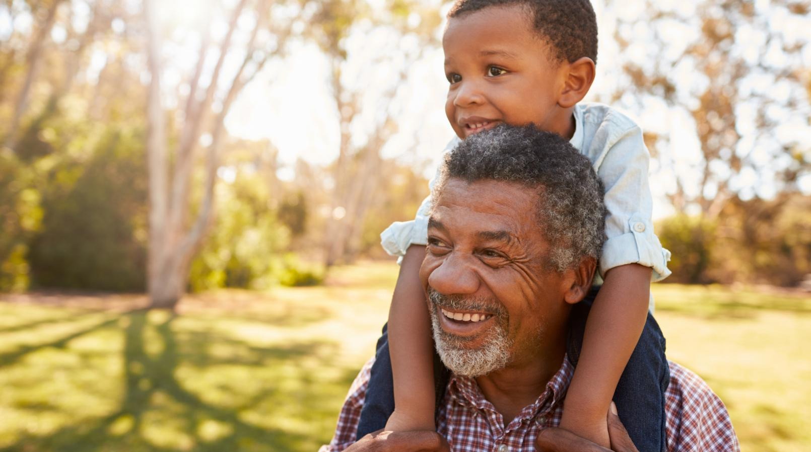 Grandchild on the shoulders of grandfather