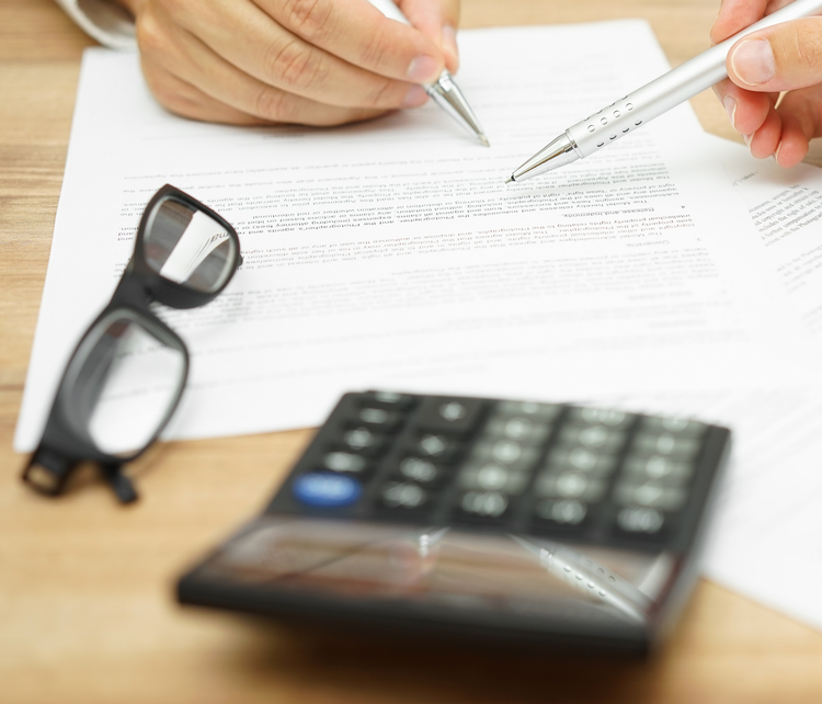 2 hands with pens pointing at document