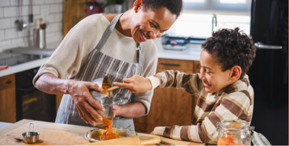 Woman cooking with child.
