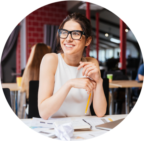 Woman sitting at desk smiling with work in front of her