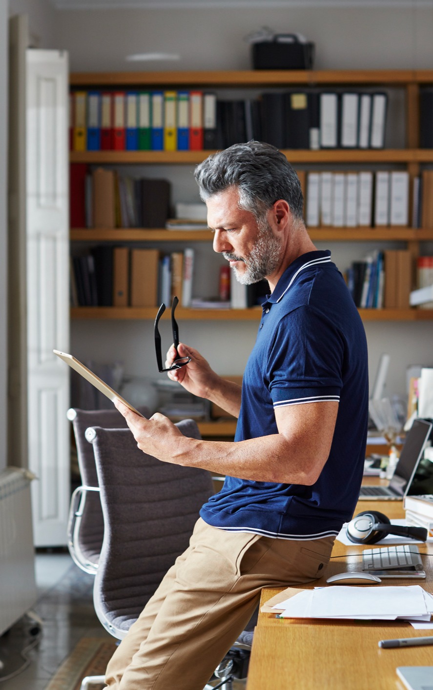 Man in Office Looking at Document