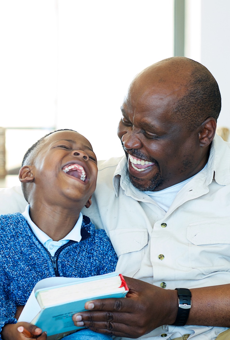 man reading a book with a boy