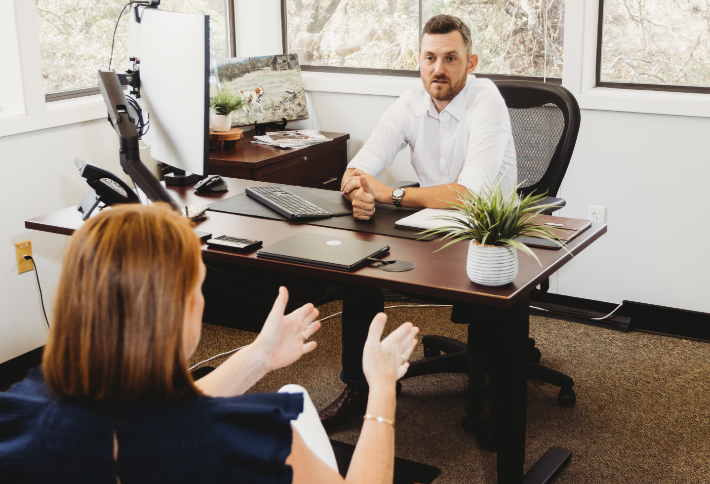 two people having a discussion in an office
