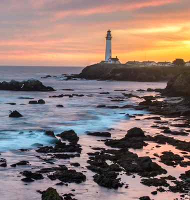 Lighthouse on a cliff at sunset