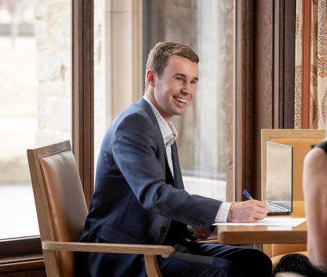 Thornton Brown from the Brown Ruth Advisors team smiling while writing