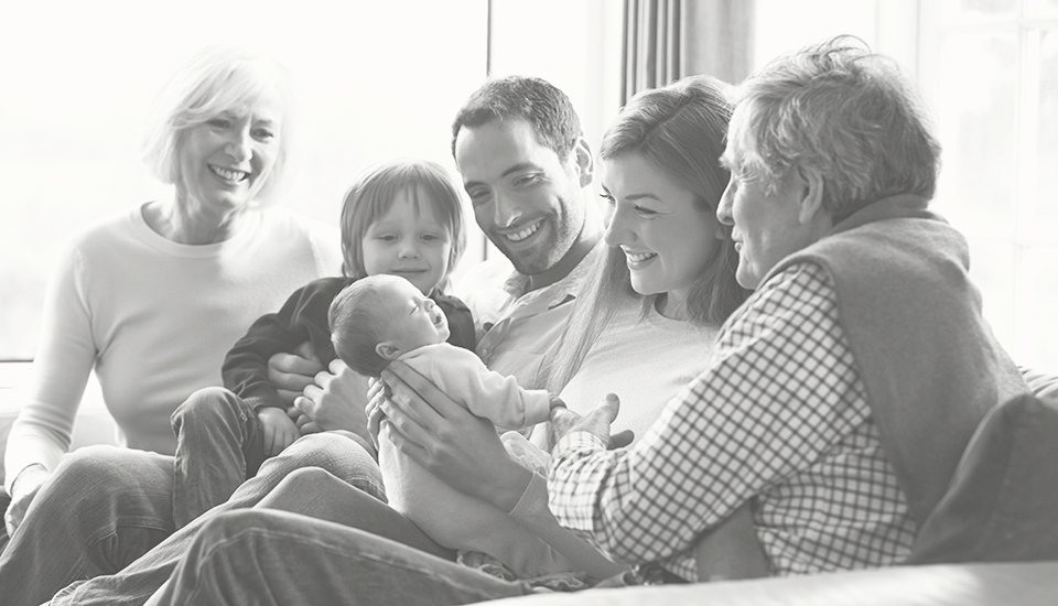 family-gathered-together-on-couch-with-child