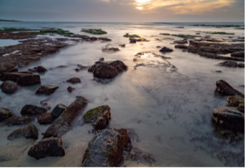 Rocky beach reflecting sun