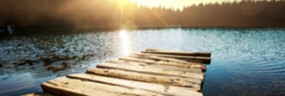 Lake with a dock during sunset