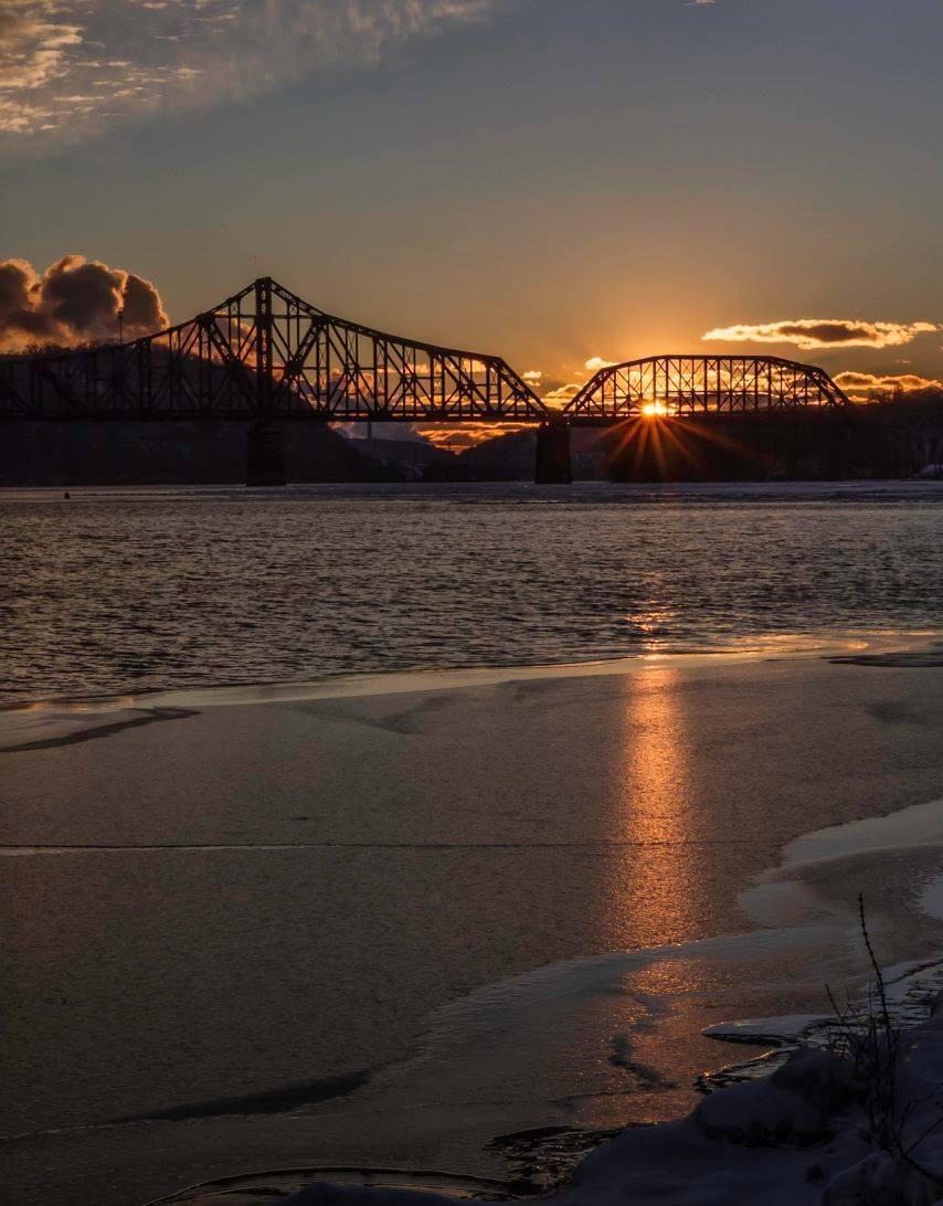 Bridge in the water near the beach on sunset