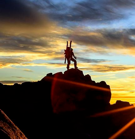 Hiker on the top of a mountain enjoying the view