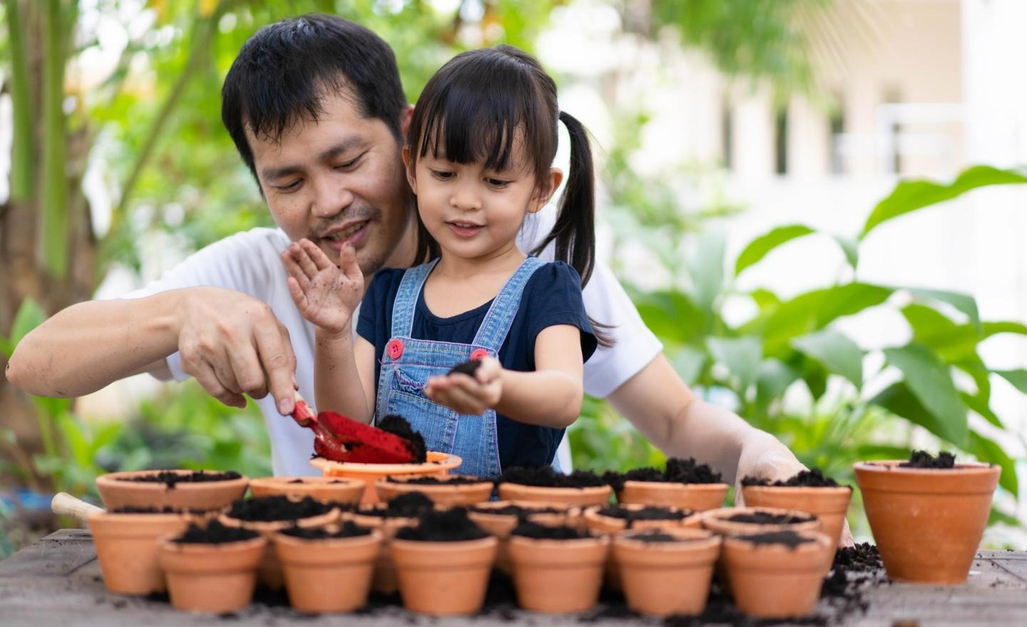 father and daughter gardening