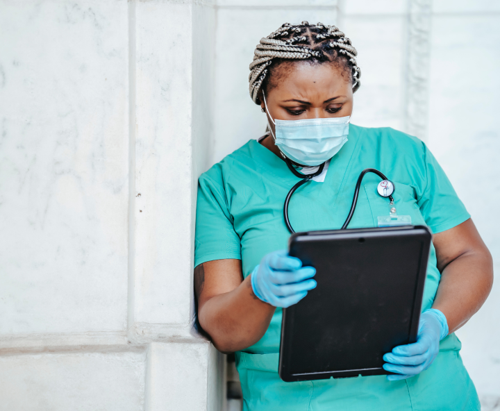 medical professional looking at information on a tablet