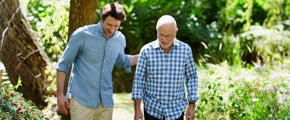 Man walking with an elderly man outside