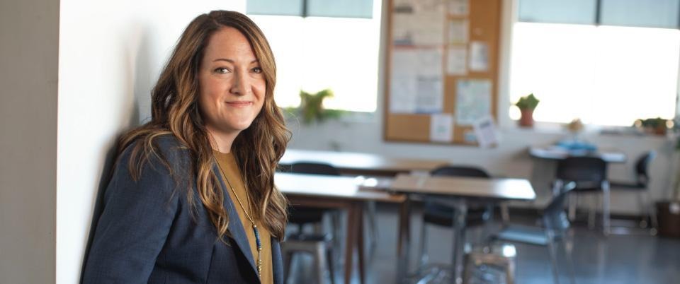 Smiling woman with desks in the background