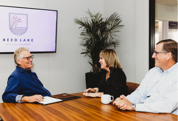 three people having a meeting in the Reed Lake Private Wealth office