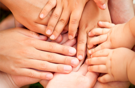 Hands of various sizes uniting