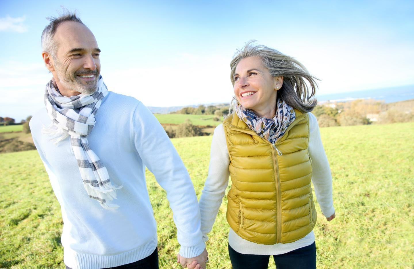 couple roaming in a meadow