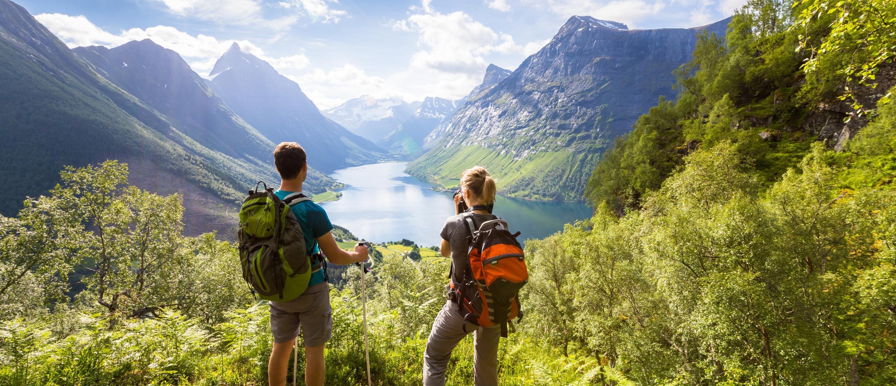 Photo of two people enjoying a beautiful valley view
